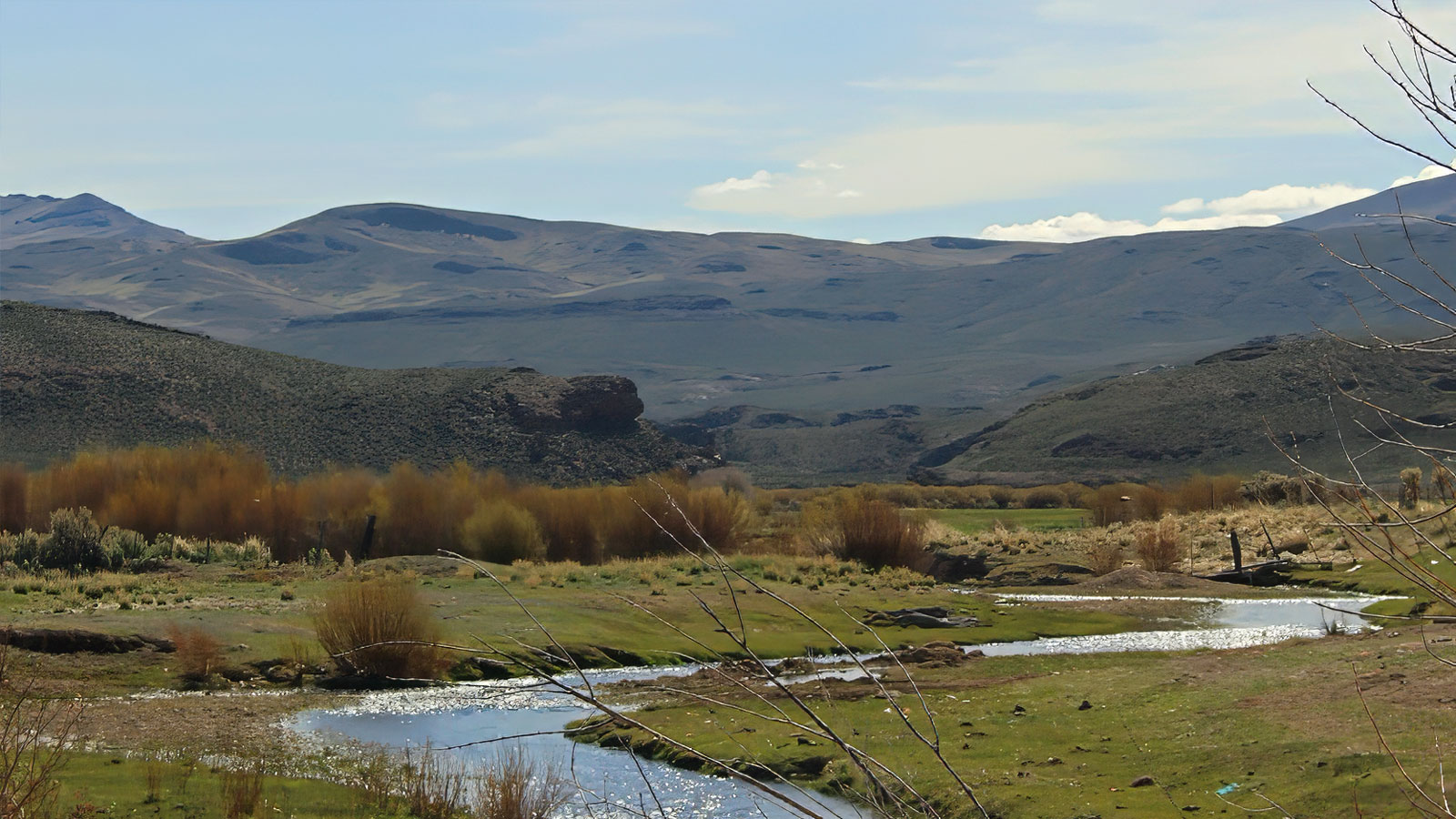 Winding creek and hills at Bell Brand Ranch